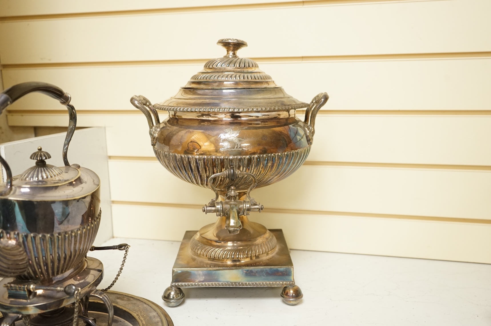 A Victorian silver plated urn, height 42cm, a silver plated spirit kettle and two circular dishes.
